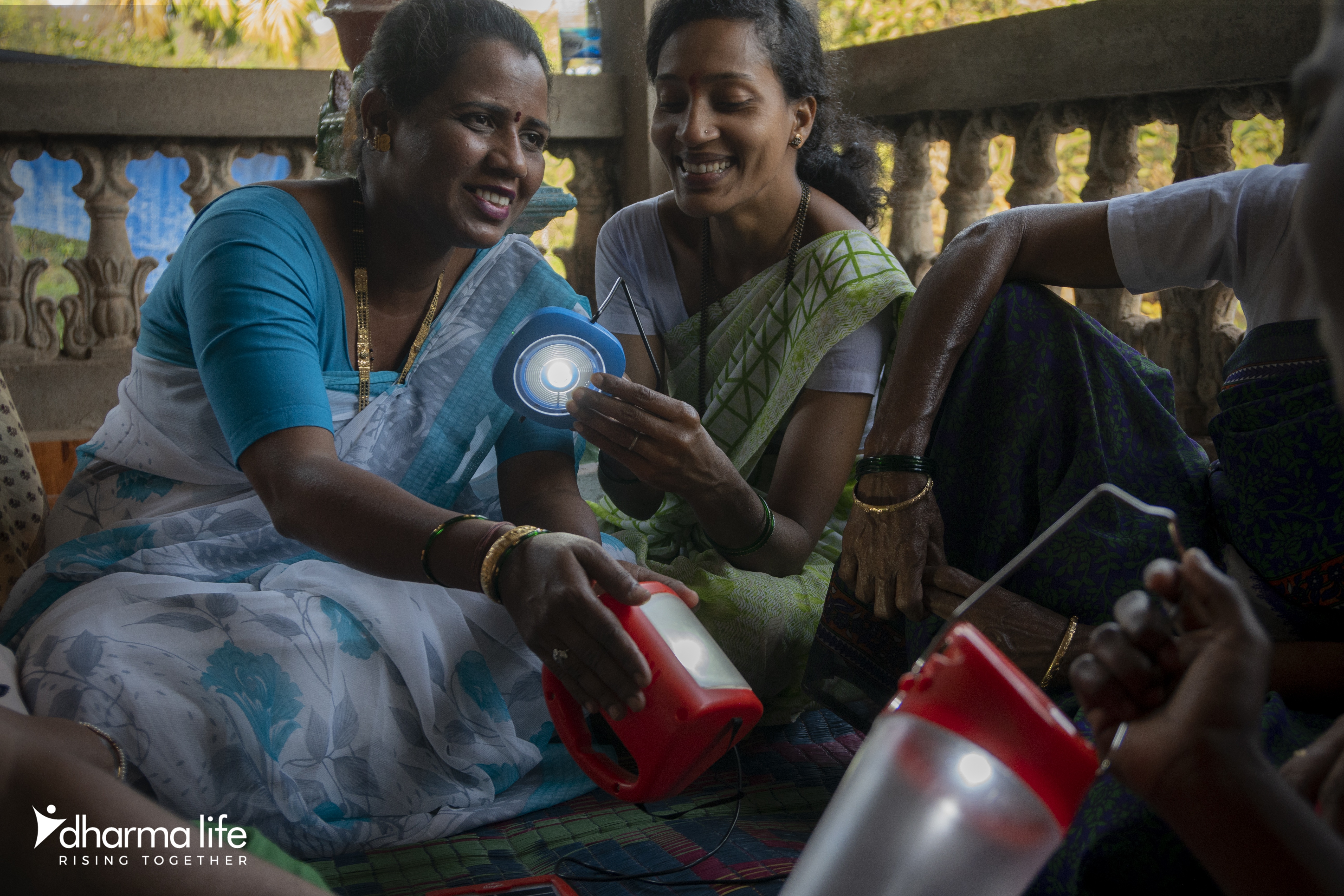 2 Indian ladies looking at solar lanterns