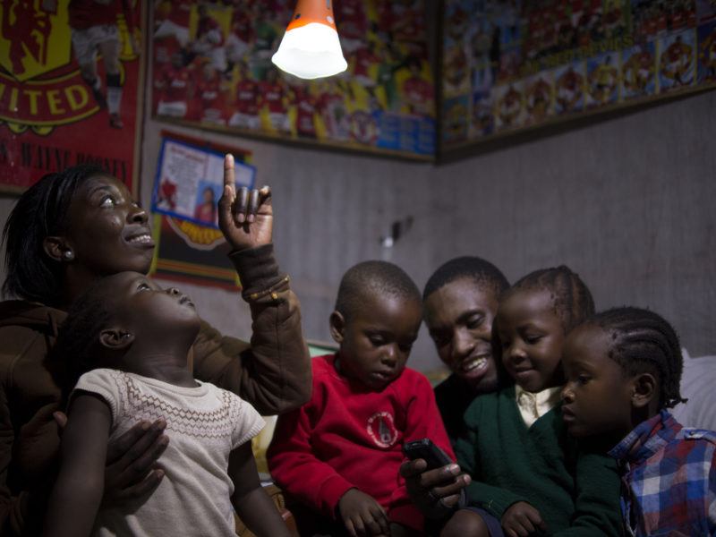 African family in room with solar light above